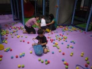 With friends picking up foam balls