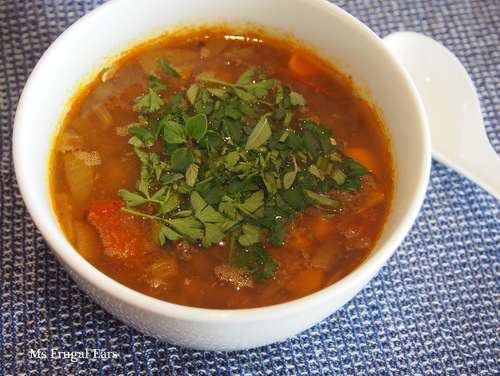 Delicious topped with parsley, a bowl of lamb barley soup