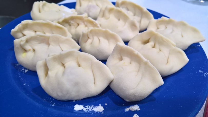 A plate of fresh dumplings ready to be cooked